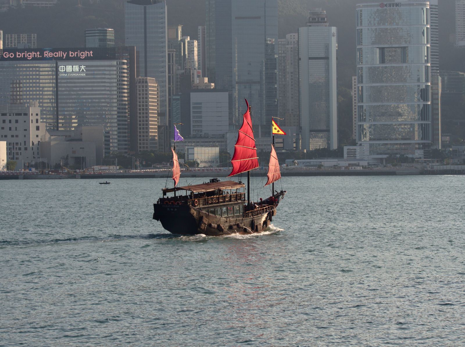 Junk boat sailing past limestone islands